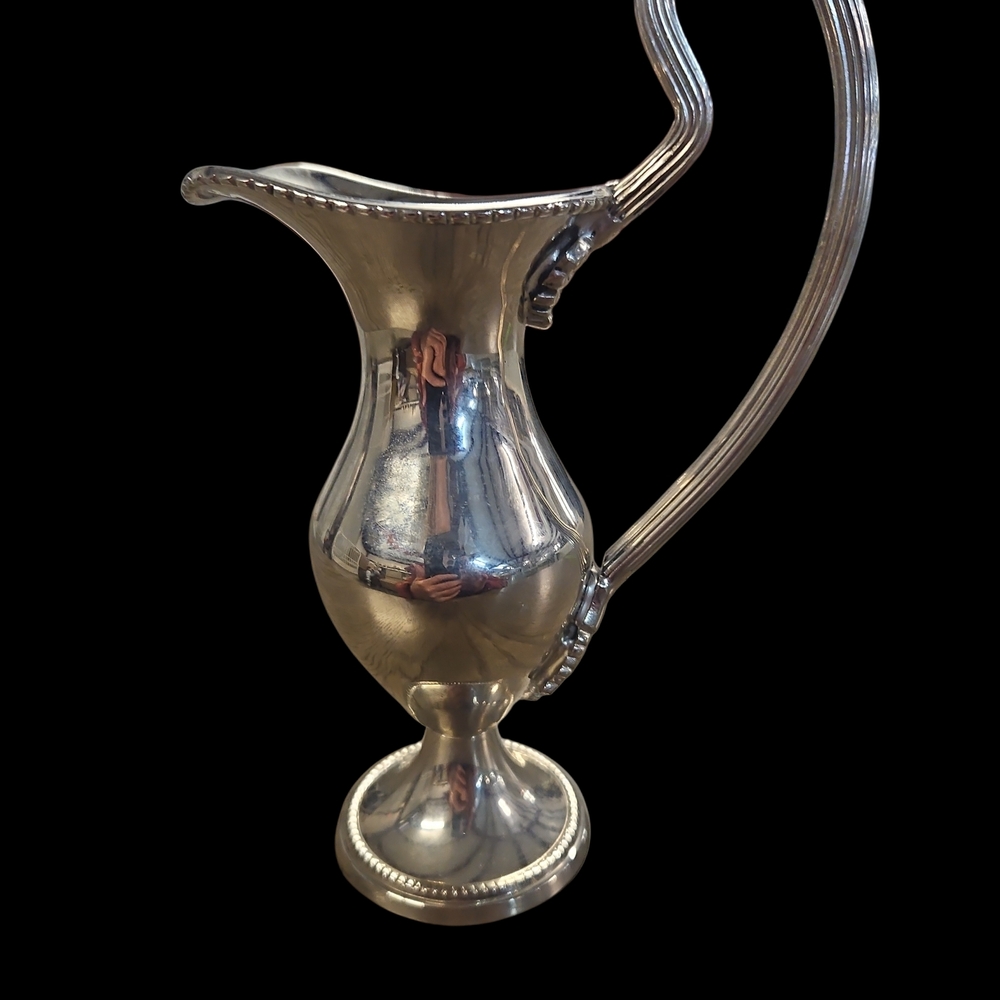 Elegant Silver Pitcher with Ornate Handle